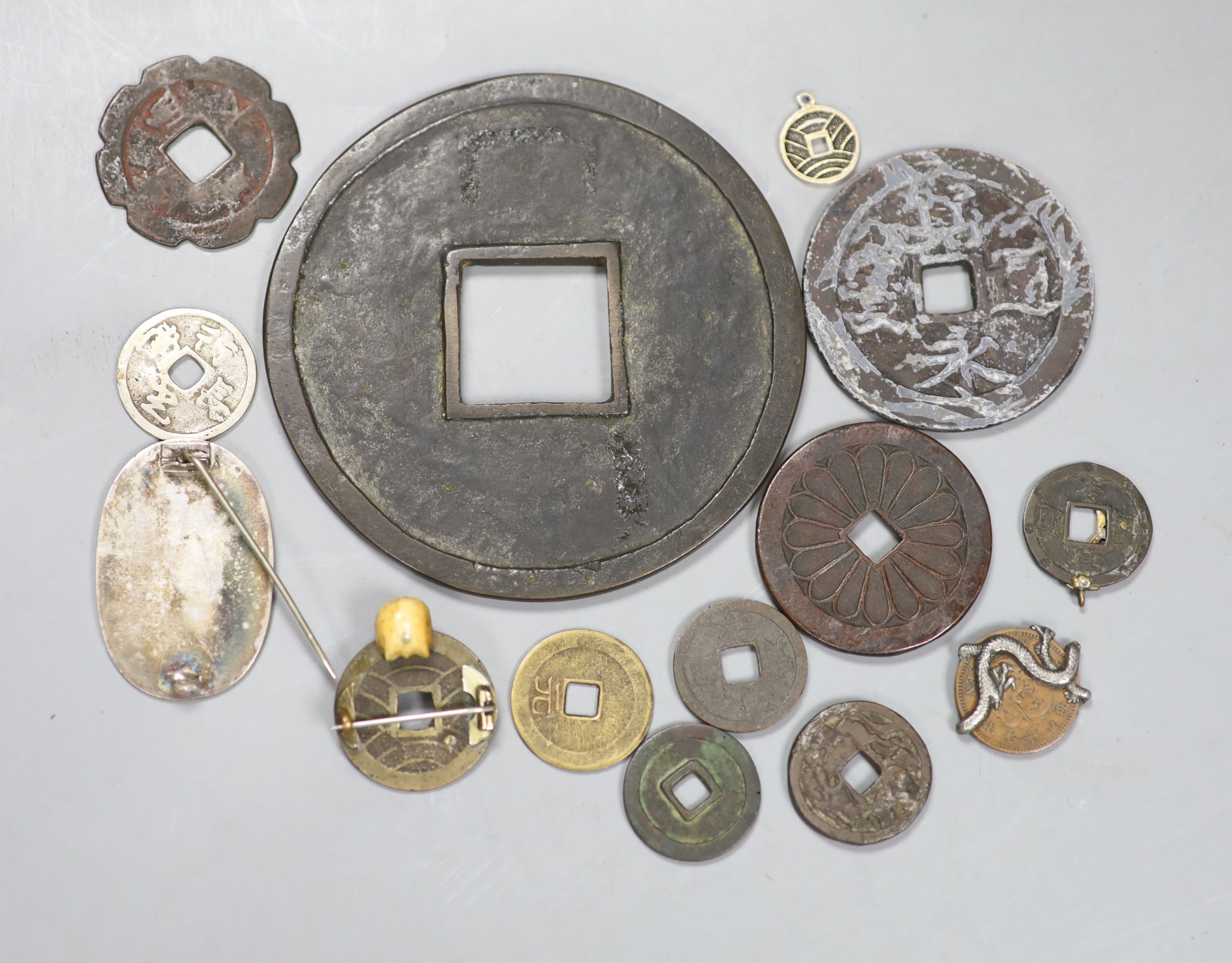 A group of Japanese bronze coin charms or amulets, 19th/20th century,